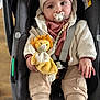 Ezio a rejoint le concours — aidez-le/la à gagner de superbes lots ! baby, child, car_seat, pacifier, plush_toy, lion_toy, beanie, sweater, pants, hands, face, eyes, indoor, seatbelt, safety, cute, infant, warm_clothing, toy, comfort