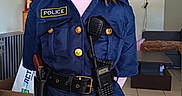 Léana participe au concours pour gagner de l'argent avec cette photo : badge, child, clock, confident, costume, face, floor_tiles, furniture, hat, home, indoor, living_room, person, police_costume, pretend, role_play, smile, standing, toy_radio, young_girl