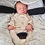 baby, sleeping, onesie, hedgehog_pattern, blanket, car_seat, infant, soft_fabric, cozy, peaceful, child, newborn, cute, hands, face, pajamas, animal_print, comfort, rest, indoors