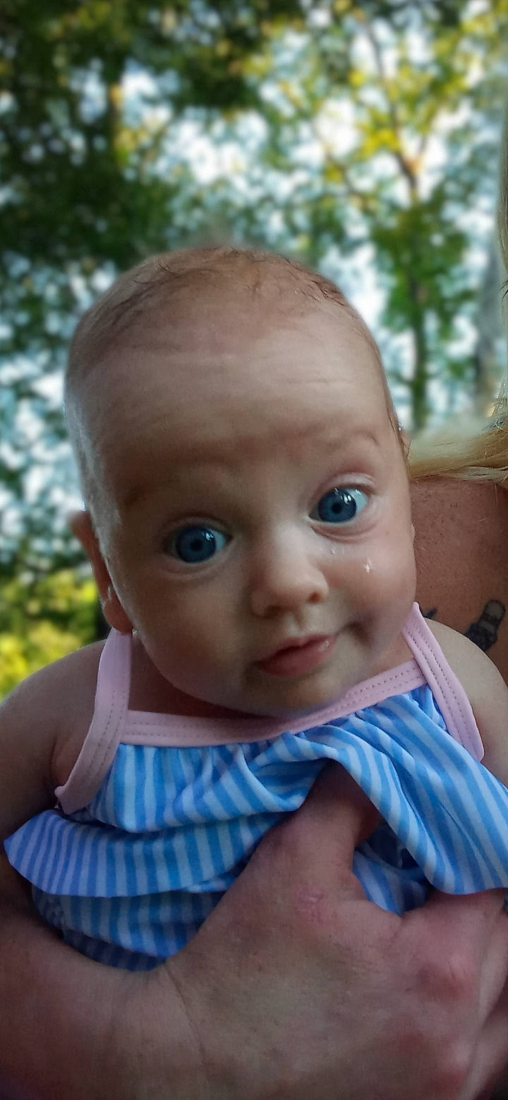 Raelin is registered to the contest to win money with this photo: baby, baby_toddler_clothing, blond, cheek, child, eyebrow, eyelash, fun, grass, happy, iris, leisure, lip, nose, person, sitting, skin, toddler, tree, vacation