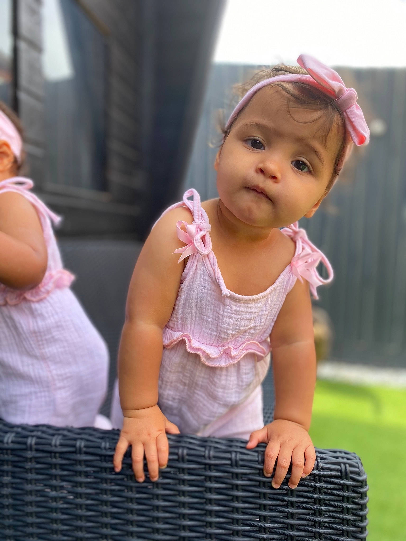 Elsie And Ivy is registered to the contest to win money with this photo: baby, baby_toddler_clothing, clothing, dress, face, fun, gesture, grass, happy, human_body, leisure, magenta, person, pink, recreation, sitting, skin, sleeve, t_shirt, toddler