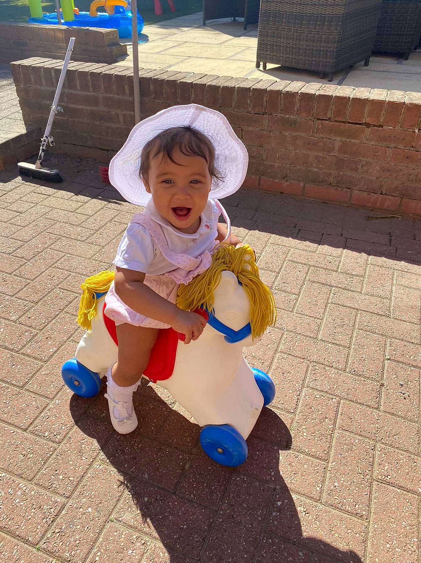 Elsie And Ivy joined the competition — help win amazing prizes! baby, baby_toddler_clothing, bench, boot, child, flooring, fun, grass, happy, hat, human_leg, leisure, person, play, recreation, road_surface, sandal, sidewalk, sitting, sun_hat