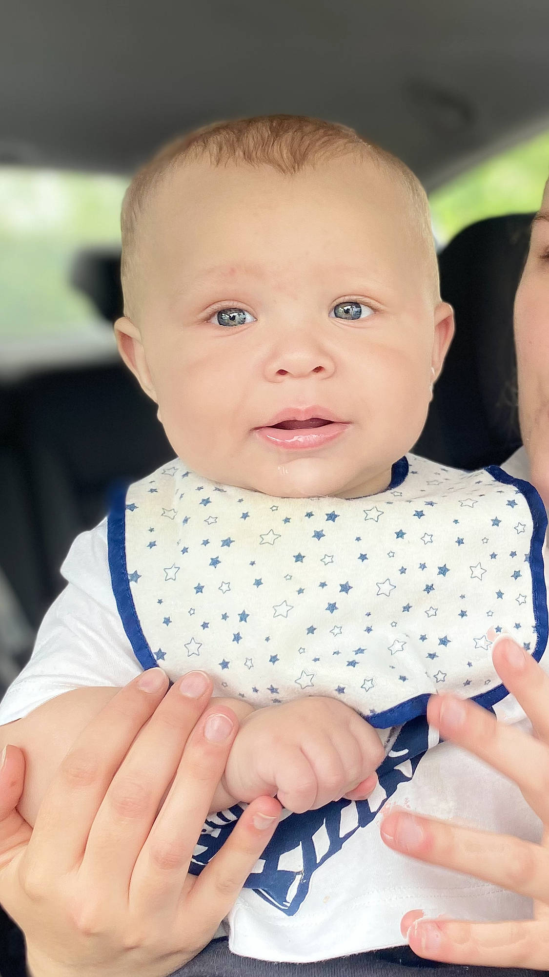 Tre is registered to the contest to win money with this photo: baby, baby_toddler_clothing, cheek, child, dress, electric_blue, finger, gesture, hand, happy, lip, mouth, nail, neck, nose, pattern, person, skin, sleeve, thumb