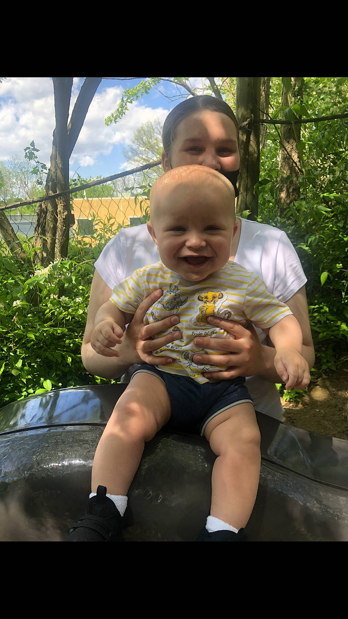 Tre is registered to the contest to win money with this photo: baby, baby_products, child, cloud, fun, grass, happy, landscape, leaf, leg, leisure, people_in_nature, person, plant, recreation, sitting, sky, smile, t_shirt, toddler