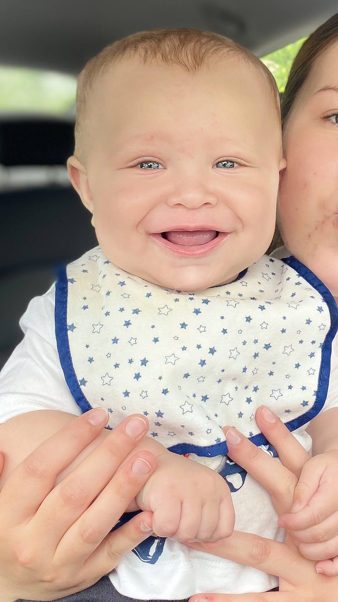 Tre is registered to the contest to win money with this photo: baby, baby_toddler_clothing, blue, cheek, dress, face, finger, gesture, hand, happy, iris, joy, kiss, nail, nose, people_in_nature, person, pink, skin, sleeve