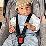 baby, child, car_seat, cap, overalls, stripes, straps, foot, hand, bracelet, indoor, seat, fabric, clothing, person, infant, cute, safety, rest, young