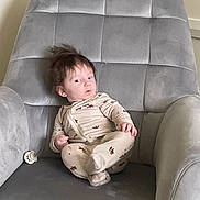 Pierce joined the competition — help win amazing prizes! baby, child, infant, onesie, animal_print, gray_chair, armchair, pacifier, indoor, furniture, plush, seated, cute, curious, young_child, portrait, cozy, soft, home, relaxed