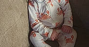 Atlas is registered to the contest to win money with this photo: baby, sleeping, pacifier, onesie, crab_pattern, couch, furniture, cozy, infant, child, nap, relaxing, indoor, soft_lighting, peaceful, cute, person, seated, resting, comfortable