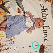 Atlas joined the competition — help win amazing prizes! baby, infant, milestone_blanket, ocean_theme, shark, fish, turtle, months_marker, striped_romper, clothing, lying_down, cute, portrait, child, newborn, blue_and_white, patterned_blanket, soft_texture, indoors, bed