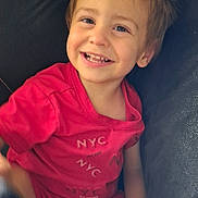 Heinrich joined the competition — help win amazing prizes! child, toddler, smiling, happy, portrait, seated, chair, indoor, pink_clothing, red_clothing, brown_hair, blue_eyes, face, teeth, arms, hands, casual, close_up, cozy, photography