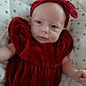 Winter joined the competition — help win amazing prizes! baby, infant, red_dress, headband, blue_eyes, polka_dot, cushion, soft_fabric, closeup, portrait, child, cute, indoors, person, newborn, clothing, smile, skin, face, baby_bed