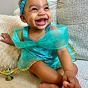 Zuri Isabella joined the competition — help win amazing prizes! toddler, child, smiling, happy, dress, headband, couch, indoor, toy, genie_lamp, barefoot, crossed_legs, cute, portrait, young_child, joyful, skin, hand, feet, fabric