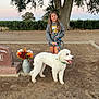 Oliver is registered to the contest to win money with this photo: girl, dog, leash, tree, flowers, gravestone, outdoor, sunset, smiling, pet, animal, nature, grass, dirt, casual_clothing, young, happy, park, walking, leisure