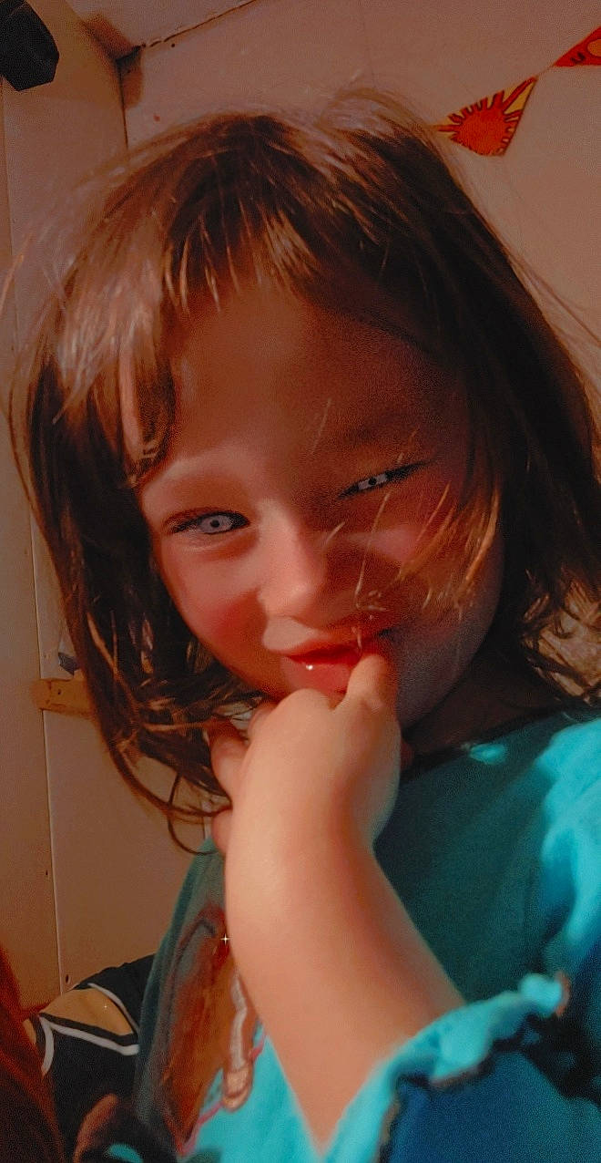 Hartley is registered to the contest to win money with this photo: arm, bangs, cheek, chin, ear, eyelash, forehead, fun, gesture, happy, iris, jaw, joy, layered_hair, lip, mouth, neck, nose, person, skin