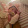 Renatta joined the competition — help win amazing prizes! baby, blanket, bow, close_up, cozy, cute, hand, headband, indoor, infant, newborn, pacifier, person, pink_clothing, resting, sleepy, soft_lighting, striped_bed, tender, warm