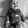 baby, black_and_white, blanket, child, clothing, cozy, cute, face, happy, head, indoor, infant, jeans, long_sleeve_shirt, person, portrait, sitting, smiling, soft_lighting, texture