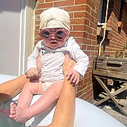 Alénya participe au concours pour gagner de l'argent avec cette photo : arms, baby, brick_wall, cute, foot, hands, head_wrap, infant, outdoor, person, pool, posing, shadows, skin, summer, sunglasses, sunlight, water, white_clothing, wooden_planter