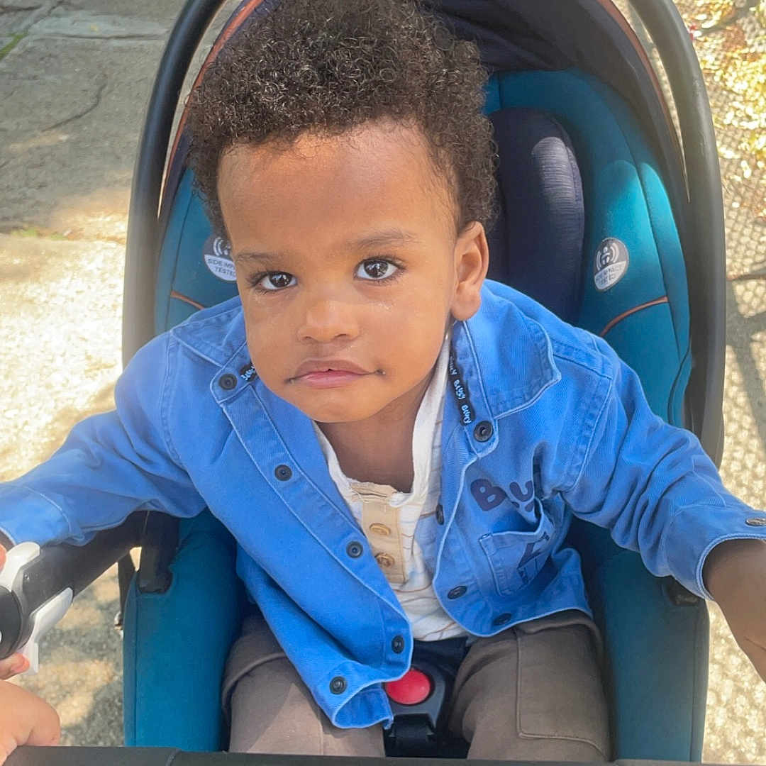 Zayden is registered to the contest to win money with this photo: boy, child, city, clothing, coat, face, grass, head, jacket, male, nature, outdoors, pants, park, person, photography, portrait, road, street, urban