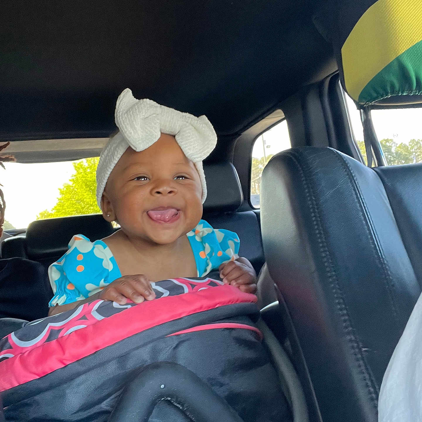 Amara is registered to the contest to win money with this photo: adult, baby, baseballcap, cap, car, clothing, cushion, face, happy, hat, head, homedecor, male, man, person, photography, portrait, smile, transportation, vehicle