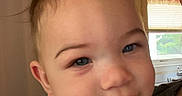 Karri joined the competition — help win amazing prizes! baby, child, infant, portrait, close_up, smiling, tongue_out, blue_eyes, brown_hair, white_shirt, being_held, adult, indoor, kitchen, window, shelves, home, warm_lighting, happy, face