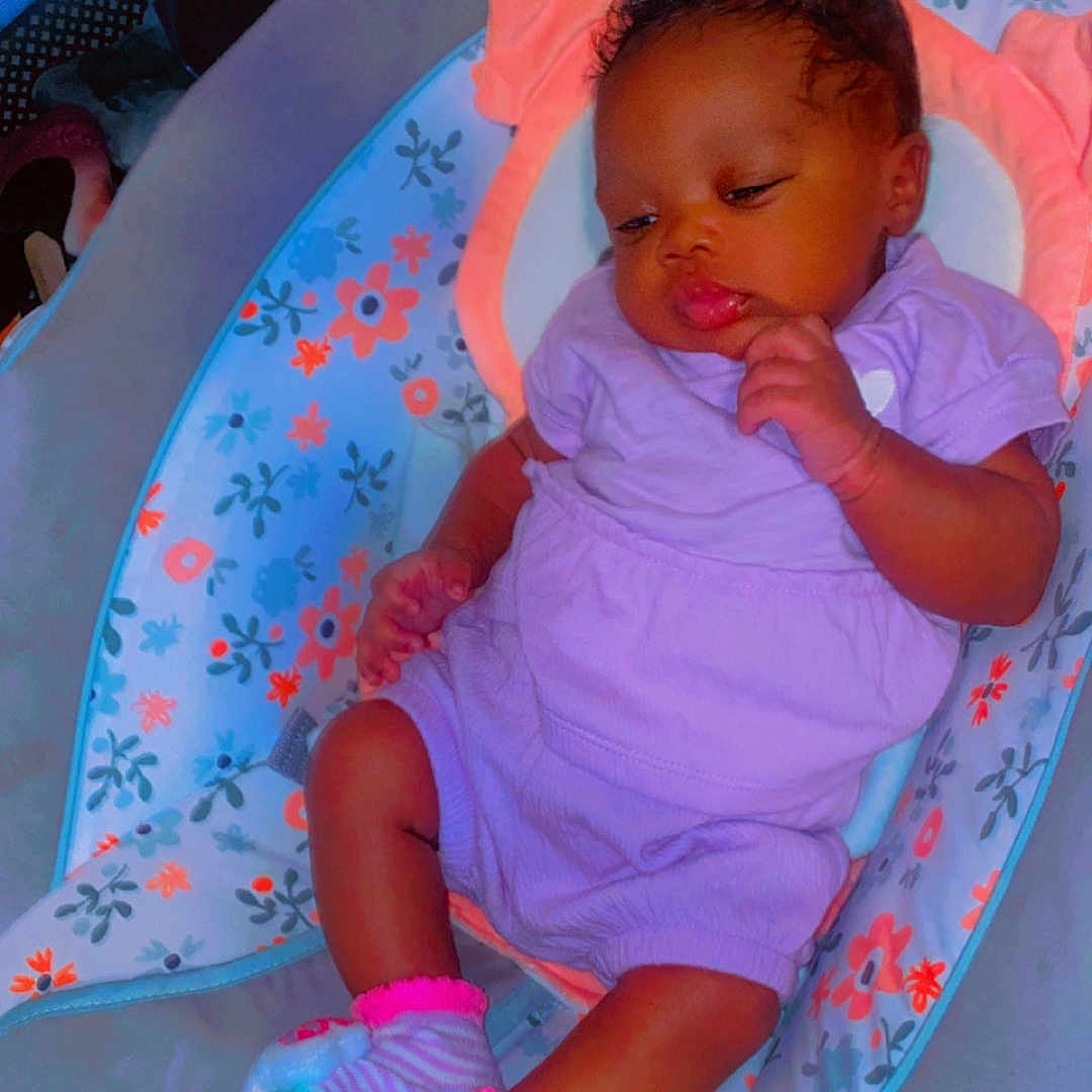 Sevyn is registered to the contest to win money with this photo: baby, bed, bodypart, clothing, crib, cushion, cutlery, face, finger, footwear, furniture, hand, head, homedecor, infantbed, person, photography, portrait, shoe, spoon