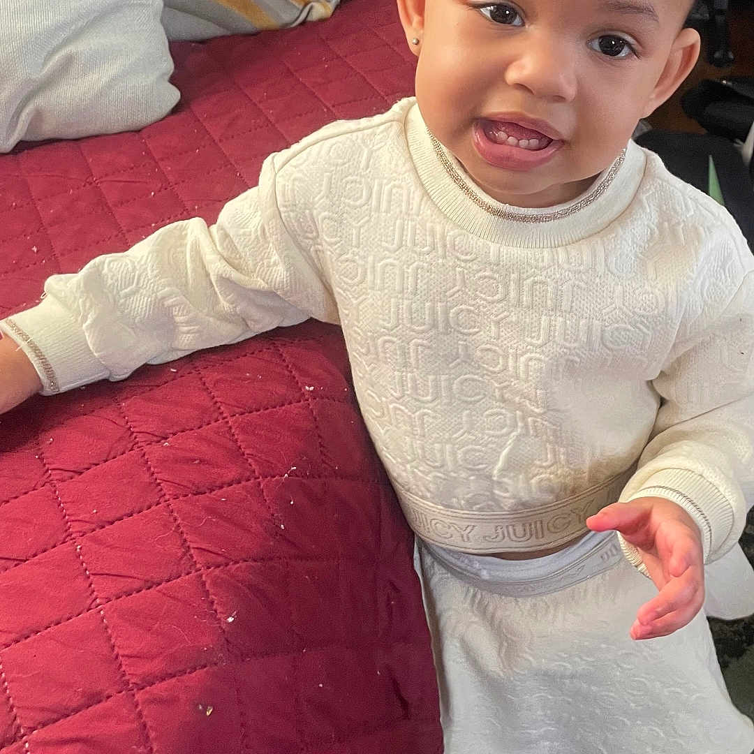 Mikia Marie Owens is registered to the contest to win money with this photo: child, couch, curious, cute, face, fashion, footwear, furniture, happy, home, indoor, person, pillow, quilted, smiling, sneakers, standing, toddler, white_clothing, young_child