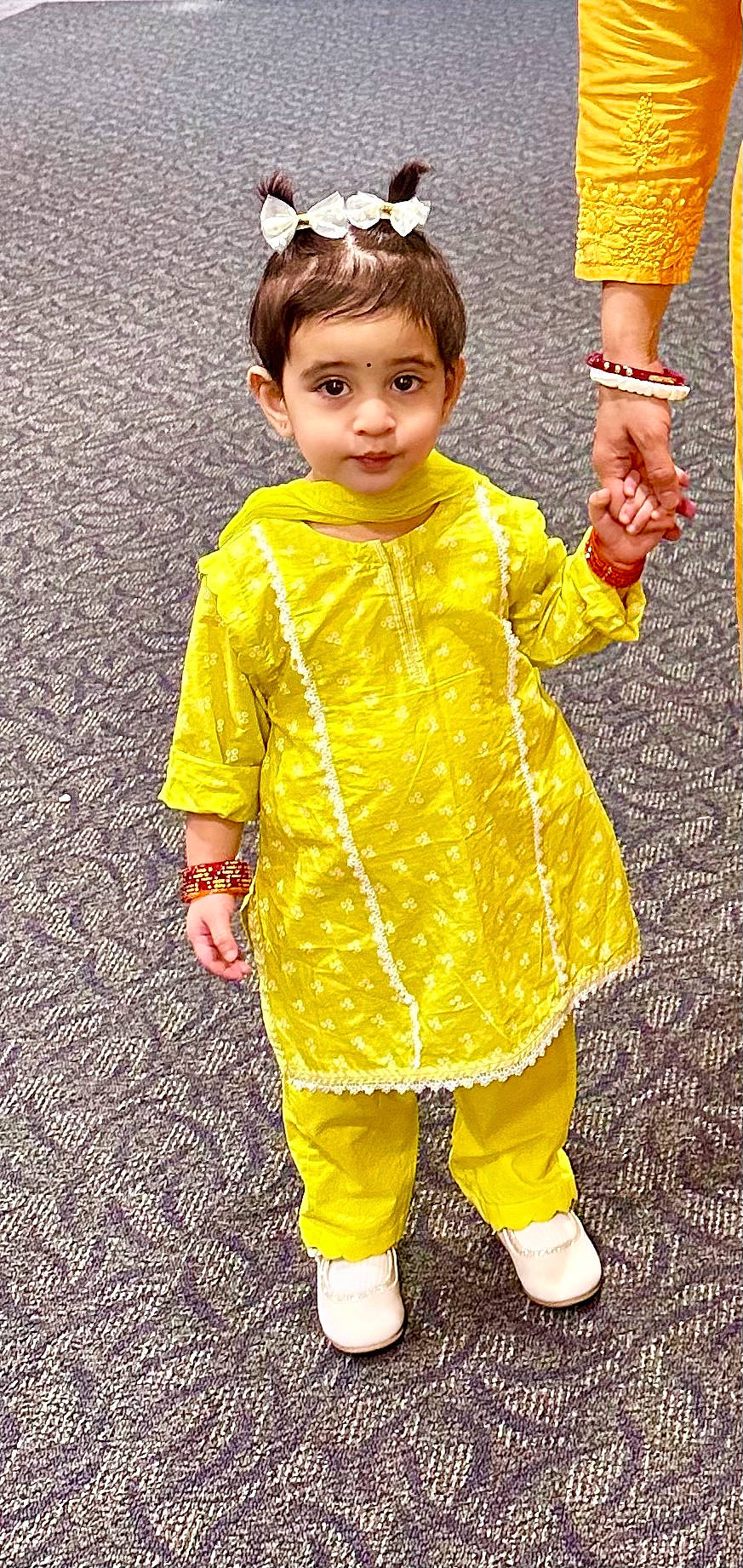 Prisha is registered to the contest to win money with this photo: baby_toddler_clothing, child, dress, face, fun, gesture, grass, hair, hairstyle, hand, happy, head, people_in_nature, person, photograph, skin, sleeve, smile, standing, toddler