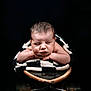 Axel is registered to the contest to win money with this photo: newborn, baby, sleeping, blanket, skateboard, infant, face, skin, arms, hands, black_background, portrait, peaceful, cute, soft, child, resting, studio_photo, closeup, cozy