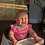 Charlie joined the competition — help win amazing prizes! baby, child, infant, smiling, pink_clothing, high_chair, indoor, sunlight, face, happy, person, furniture, carpet, laundry_basket, plastic_tray, foot, hand, tongue_out, cabinets, floor