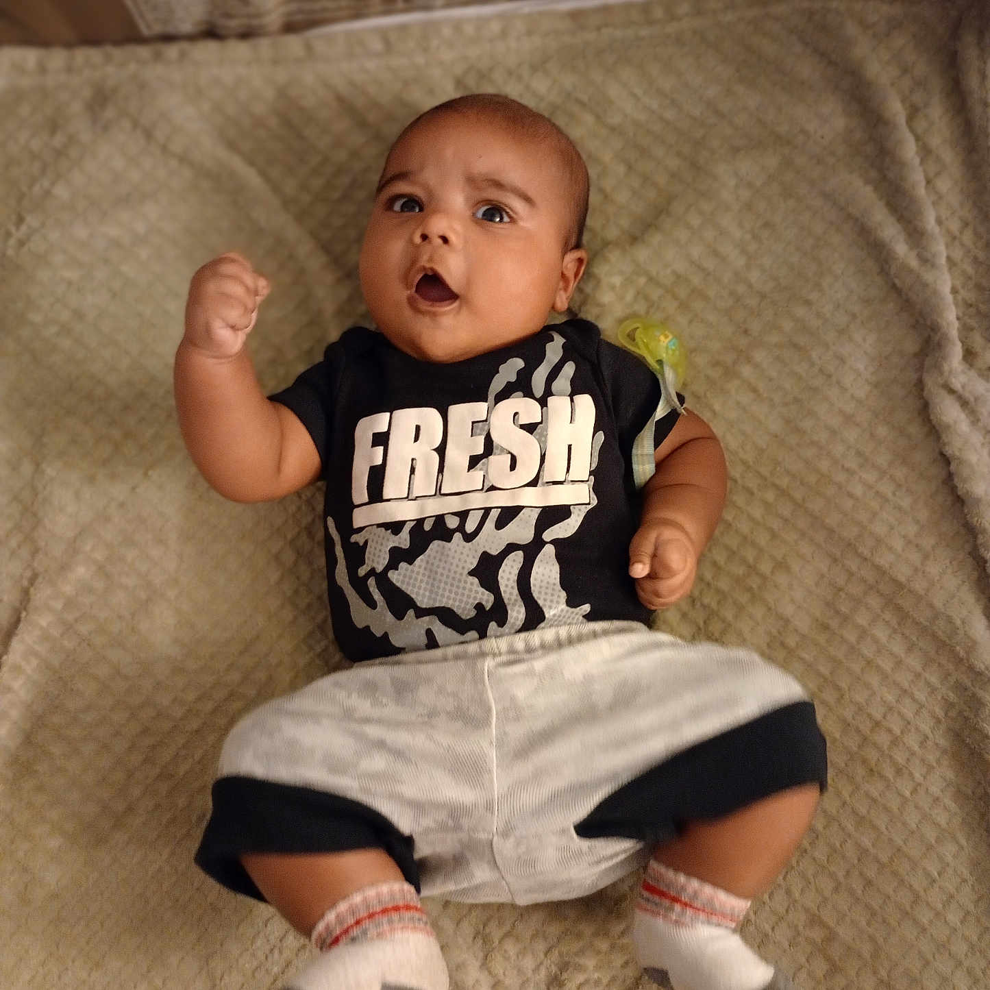 Adrian is registered to the contest to win money with this photo: baby, bodypart, clothing, couch, face, finger, footwear, furniture, hand, head, hosiery, pants, person, photography, portrait, shoe, shorts, sitting, sock, t_shirt