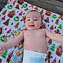 baby, infant, diaper, blanket, holiday_theme, christmas, gingerbread, wreath, tree, wooden_floor, smile, face, arms, person, cute, happy, lying_down, indoors, child, skin