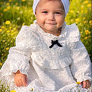 Léana participe au concours pour gagner de l'argent avec cette photo : toddler, child, white_dress, headband, bow, smiling, outdoor, flowers, meadow, grass, sunlight, portrait, baby, cute, nature, sitting, young_child, yellow_flowers, happy, innocence