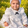 toddler, child, white_dress, headband, bow, smiling, outdoor, flowers, meadow, grass, sunlight, portrait, baby, cute, nature, sitting, young_child, yellow_flowers, happy, innocence