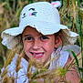 child, girl, smile, hat, white_hat, cat_face_hat, nature, grass, outdoor, greenery, portrait, happy, young, cute, face, earrings, sunlight, summer, close_up, playful