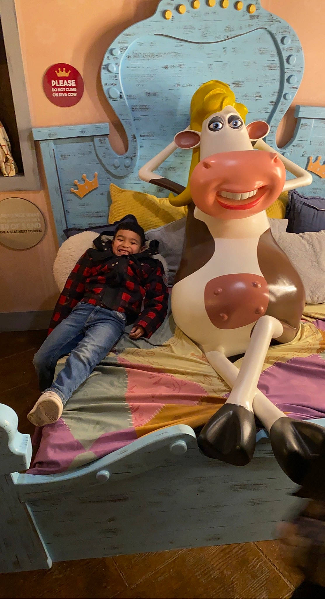 Elijah is registered to the contest to win money with this photo: animated_cartoon, animation, art, artist, child, city, entertainment, event, fiction, fictional_character, fun, games, joy, leisure, mural, person, pink, recreation, sitting, toy