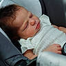 baby, sleeping, car_seat, white_clothing, infant, peaceful, child, young, portrait, close_up, seatbelt, head, face, soft_lighting, skin, hand, tiny, cute, newborn, resting