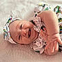 Bailey is registered to the contest to win money with this photo: baby, smiling, infant, headband, dress, butterfly_pattern, happy, hand, lying_down, blanket, cute, child, portrait, skin, cheerful, indoors, closeup, soft_light, baby_clothing, headwear