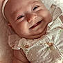 Bailey joined the competition — help win amazing prizes! baby, infant, smile, face, headband, flower, dress, cute, happy, lying_down, skin, closeup, cheeks, child, soft_light, texture, fabric, sleepwear, portrait, adorable