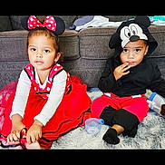 Kali is registered to the contest to win money with this photo: carpet, casual, child, children, costume, cute, disney, fun, headwear, hoodie, indoor, kids, mickey_mouse, minnie_mouse, playful, polka_dot, portrait, red_dress, sitting, sofa