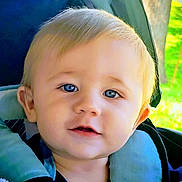 Riley joined the competition — help win amazing prizes! toddler, child, face, blue_eyes, stroller, cushion, outdoor, baby, portrait, smiling, blond_hair, young_child, seat, closeup, person, infant, daylight, happy, nature, childcare