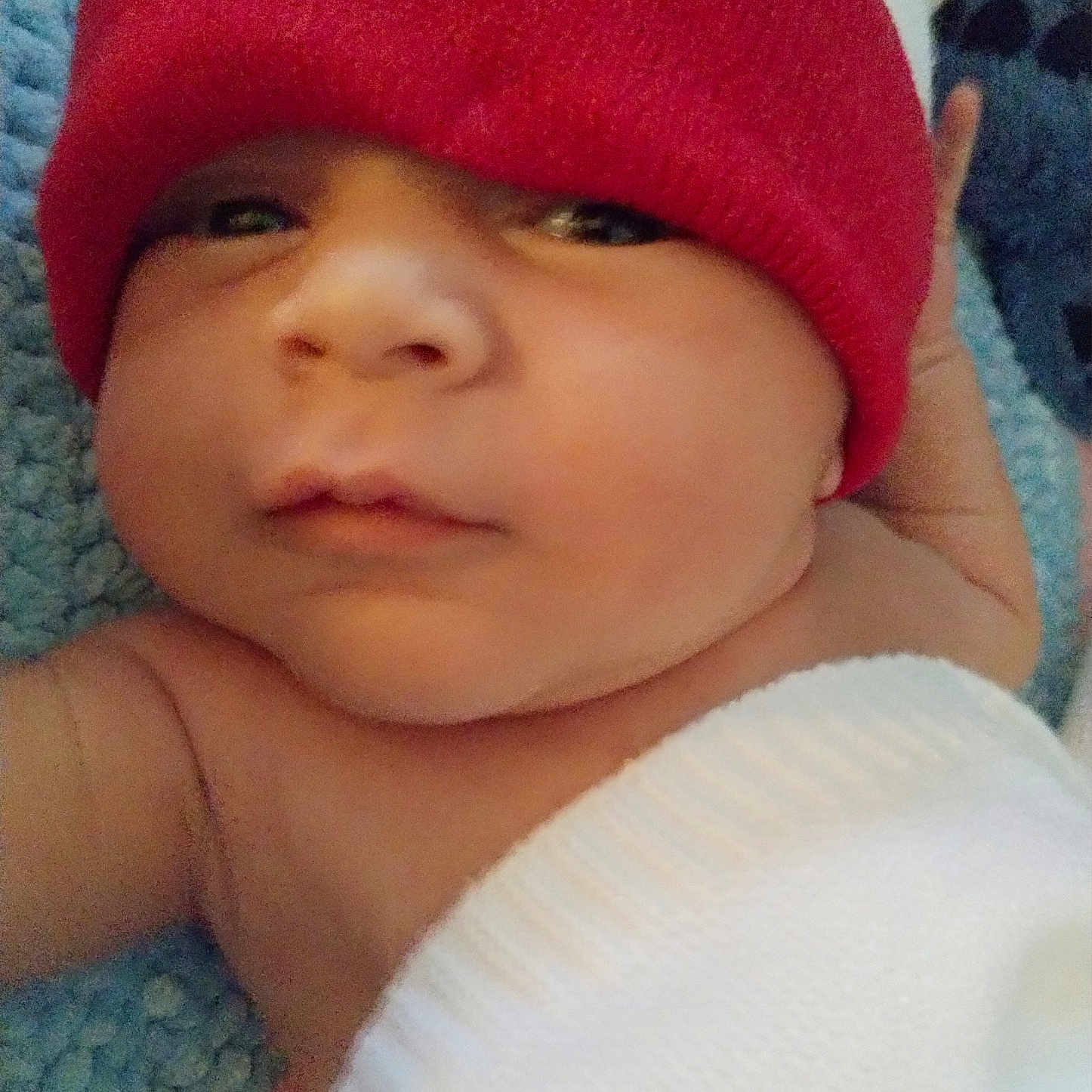 Dyvonne is registered to the contest to win money with this photo: baby, beanie, bonnet, cap, clothing, face, glove, hat, head, newborn, person, photography, portrait