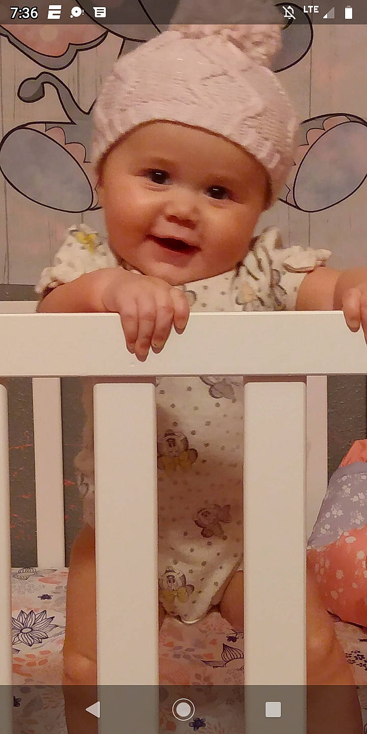 Aubree is registered to the contest to win money with this photo: baby, baby_laughing, baby_toddler_clothing, beauty, cap, cheek, child, facial_expression, finger, happy, headwear, organ, person, photograph, pink, product, skin, sleeve, smile, toddler