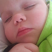 Eleanor is registered to the contest to win money with this photo: adorable, baby, calm, child, close_up, cute, expression, face, green_clothing, hand, indoors, infant, peaceful, portrait, rest, skin, sleeping, soft_focus, tiny, young