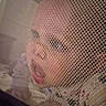 baby, child, closeup, clothing, curious, expression, eyes, face, head, indoor, infant, mesh, mouth, netting, pattern, person, playpen, skin, soft_light, texture