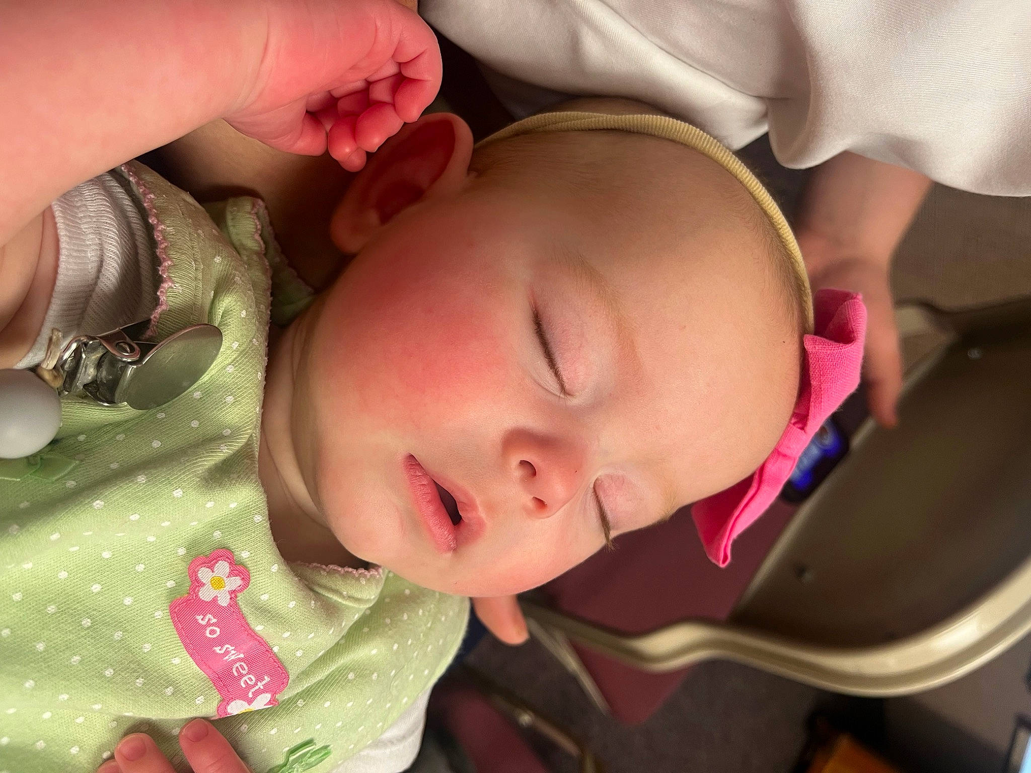 Saige is registered to the contest to win money with this photo: baby, cheek, ear, eye, eyebrow, eyelash, facial_expression, finger, gesture, hand, human_body, lip, mammal, mouth, nose, person, plant, product, skin, smile