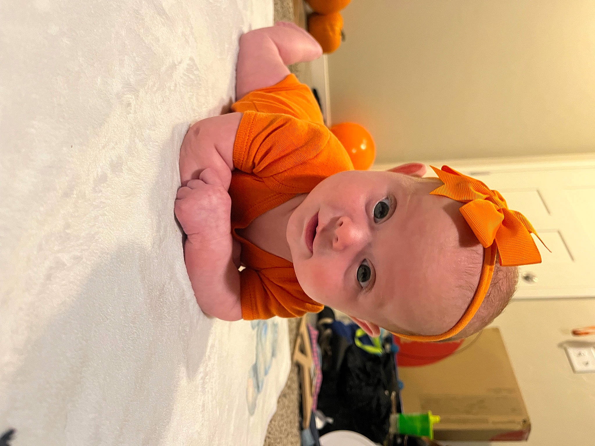 Saige is registered to the contest to win money with this photo: art, baby, baby_toddler_clothing, child, fun, happy, hat, headgear, nose, orange, peach, person, personal_protective_equipment, room, smile, toddler, vacation
