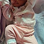May'Lanni is registered to the contest to win money with this photo: baby, infant, sleeping, pajamas, blanket, soft, cozy, pink, clothing, child, person, newborn, cute, lying_down, indoors, socks, portrait, face, resting, young
