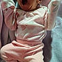 baby, infant, yawning, sleepy, pink_clothing, pajamas, blanket, soft_texture, newborn, cute, cozy, lying_down, small_hands, closed_eyes, mouth_open, infant_wear, indoors, resting, child, adorable
