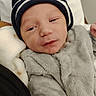 arm, baby, beanie, bed, blanket, cheeks, clothing, cozy, eyes_half_closed, face, fuzzy_clothing, hand, hat, infant, newborn, pillow, portrait, sleepy, small_person, soft_texture