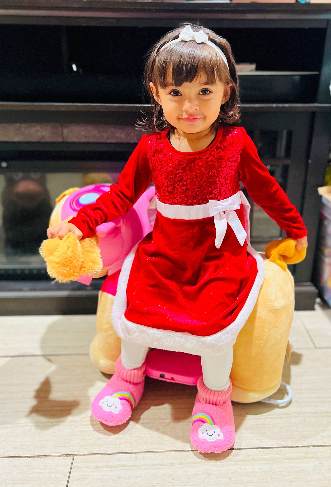 Kiana is registered to the contest to win money with this photo: baby_toddler_clothing, child, costume, doll, fashion_accessory, fashion_design, fictional_character, fun, fur, happy, human_leg, joy, magenta, one_piece_garment, pattern, person, pink, sleeve, sock, toddler